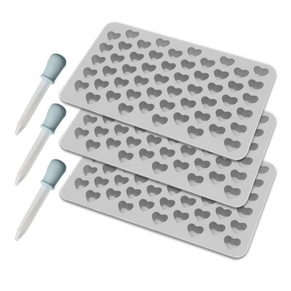 The Deal Society Silicone Gummy Heart Mold 3 Pack includes three premium trays with small heart-shaped molds and two plastic droppers with blue bulbs—perfect for versatile use in your kitchen.